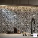 Dark grey terrazzo look ceramic wall tile with natural stone fragments pattern for modern kitchen backsplash and interior wall decoration.