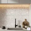 Elegant white crystal stone look ceramic backsplash tiles installed behind modern kitchen sink.